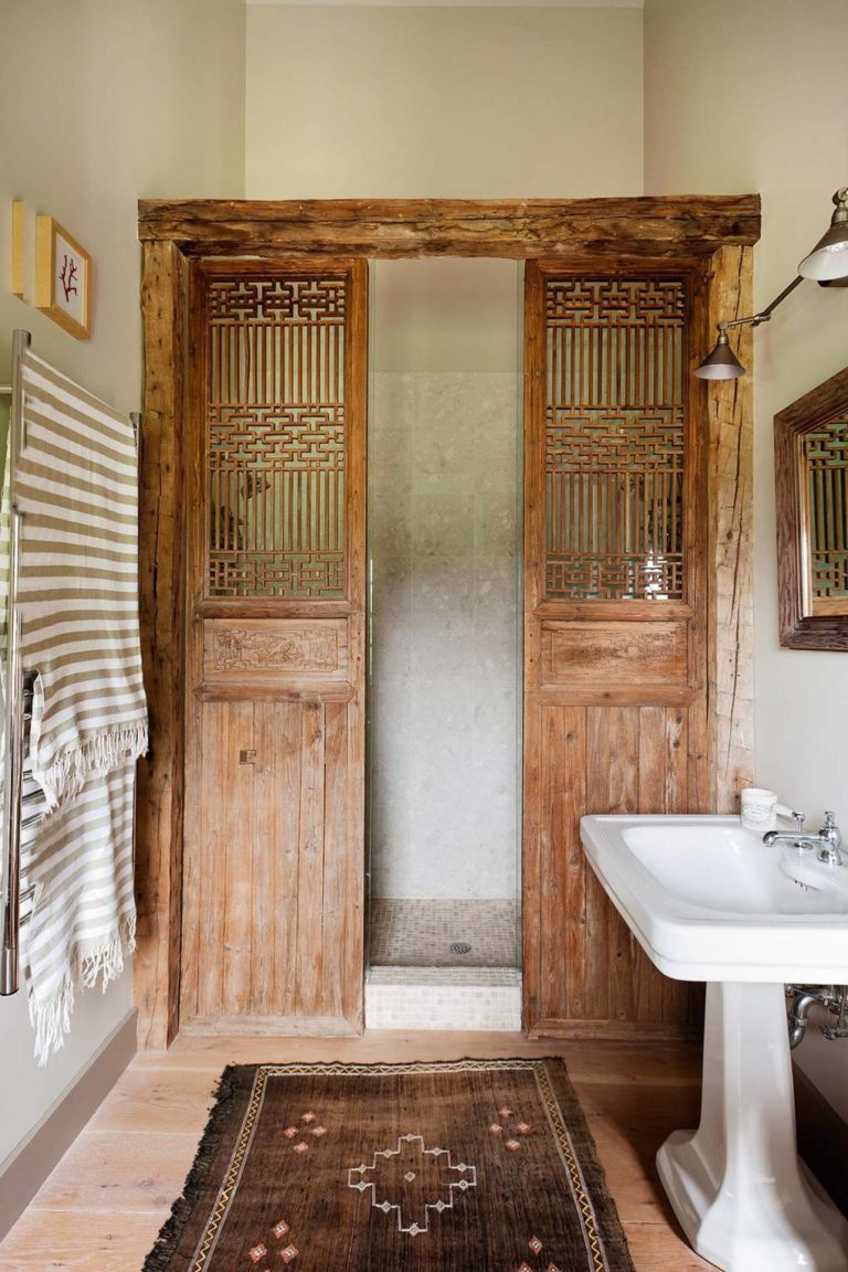 Salvaged wooden doors or screens in a bathroom by William Abrannowicz