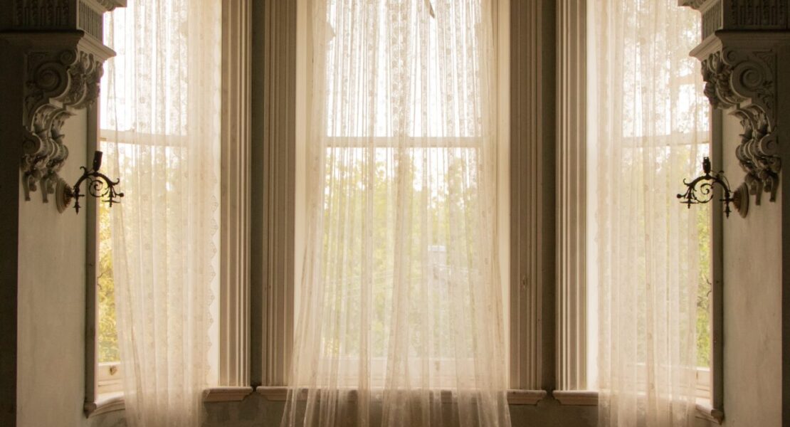 Sheer curtains in arched window room