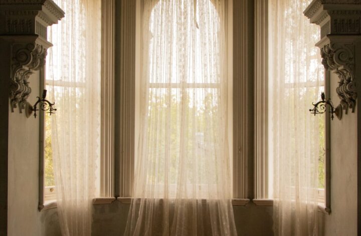 Sheer curtains in arched window room