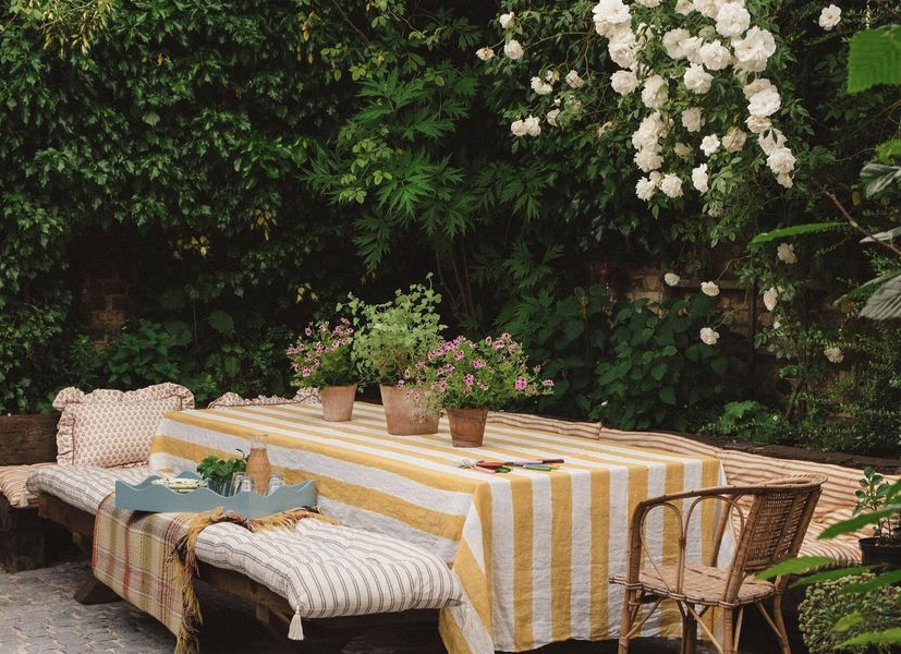 Striped dining table in the garden of Matilda Goad, photo by T Magazine